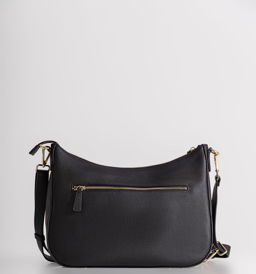 A black pebbled leather crescent-shaped shoulder bag with gold-tone hardware, a front zippered pocket, and a detachable shoulder strap, photographed against a light gray studio background.